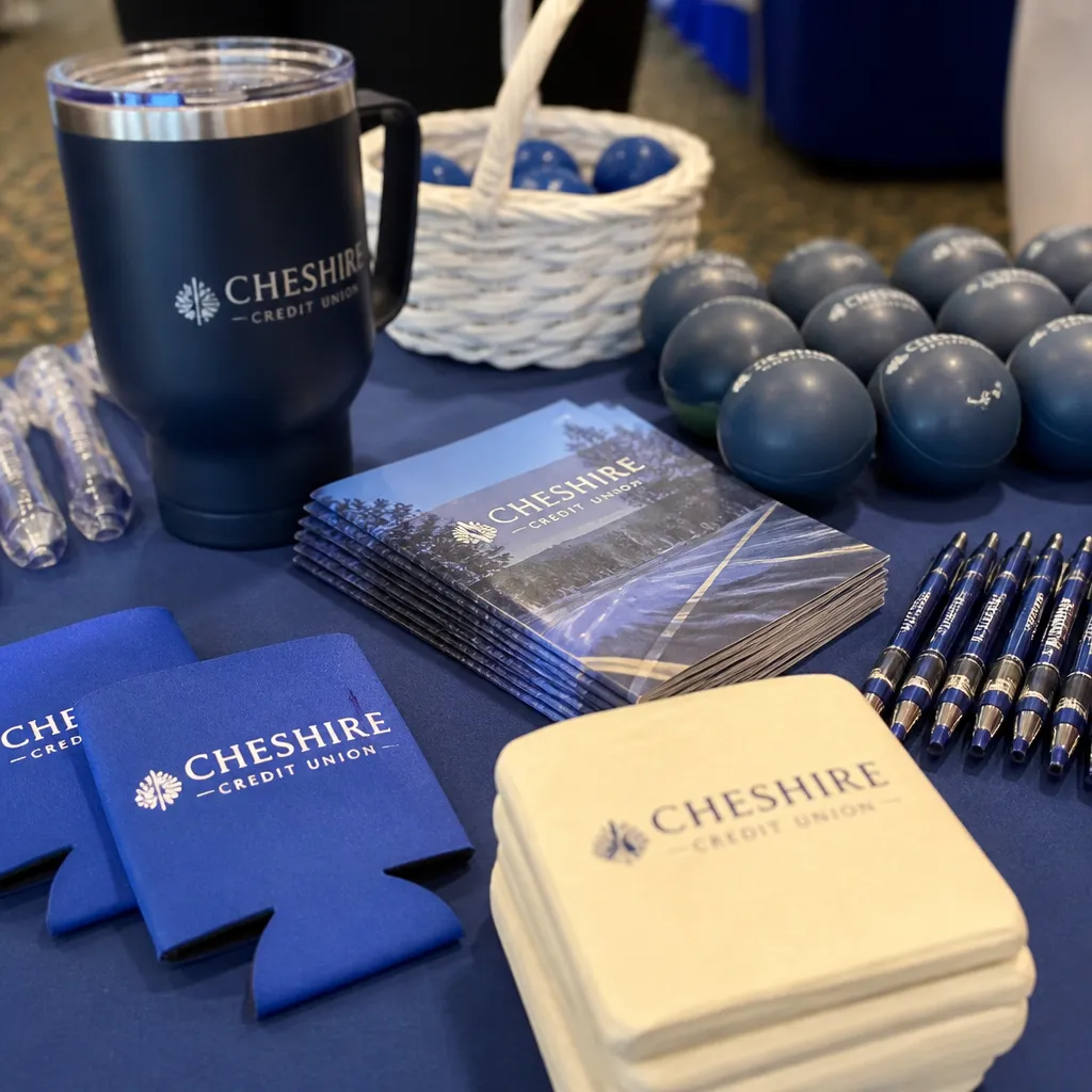 Branded program collateral, drinkware, and coasters arranged for review